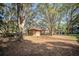 Exterior shot of a well-maintained storage shed and mature trees at 3930 Griffin Ave, Lady Lake, FL 32159