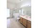 Bright bathroom featuring a glass-door shower, vanity, mirror and toilet at 3969 Derby Glen Dr, Clermont, FL 34711