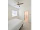 Bedroom with a view into the bathroom and ceiling fan at 3969 Derby Glen Dr, Clermont, FL 34711
