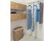 Organized walk-in closet with dresses hanging and wicker baskets for storage on shelves at 3969 Derby Glen Dr, Clermont, FL 34711