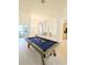 Open game room featuring a pool table and views into the foyer and living room at 3969 Derby Glen Dr, Clermont, FL 34711