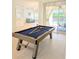 Open game room featuring a pool table and a view of the backyard at 3969 Derby Glen Dr, Clermont, FL 34711