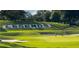 Scenic view of a golf course with sand traps, putting green, and floral display spelling 