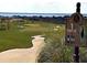 Well-maintained golf course view with course marker and water feature in the distance at 3969 Derby Glen Dr, Clermont, FL 34711