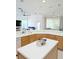 Open-concept kitchen featuring an island with a white countertop and bar seating overlooking the living area at 3969 Derby Glen Dr, Clermont, FL 34711