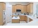 Bright kitchen boasting white countertops, stainless steel appliances, and stylish light wood cabinets at 3969 Derby Glen Dr, Clermont, FL 34711