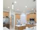 Bright kitchen featuring stainless steel appliances and a central island with white countertop at 3969 Derby Glen Dr, Clermont, FL 34711