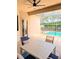 Covered lanai with table and chairs overlooking the crystal-clear pool at 3969 Derby Glen Dr, Clermont, FL 34711