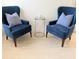 Cozy living room showcasing two comfortable blue chairs and a decorative side table at 3969 Derby Glen Dr, Clermont, FL 34711