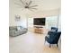 Spacious living room with a ceiling fan, tile floors, natural light, and comfortable seating creates an inviting atmosphere at 3969 Derby Glen Dr, Clermont, FL 34711
