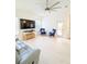 Bright living room featuring a large television, tile floors, and comfortable seating arrangements at 3969 Derby Glen Dr, Clermont, FL 34711