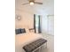 Main bedroom featuring light-filled space, white tray ceiling, barn door, and grey upholstered bench at 3969 Derby Glen Dr, Clermont, FL 34711