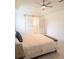 Main bedroom featuring light-filled space, white tray ceiling and a sliding barn door at 3969 Derby Glen Dr, Clermont, FL 34711