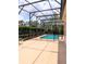 A screened-in pool with clear, blue water surrounded by lush landscaping, offering a serene and private outdoor retreat at 3969 Derby Glen Dr, Clermont, FL 34711