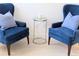 Charming sitting area featuring blue armchairs, an accent table, and neutral decor create a cozy and inviting atmosphere at 3969 Derby Glen Dr, Clermont, FL 34711