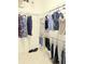 A well-organized walk-in closet with shelving and hanging rods for clothes and storage boxes, maximizing space and convenience at 3969 Derby Glen Dr, Clermont, FL 34711