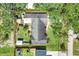 Aerial view of the backyard featuring mature trees, landscaping, shed, and fenced in area at 410 E Gulley Ave, Oakland, FL 34760