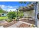 Backyard view showcasing a tranquil seating area, wood-chip ground cover, and mature landscaping at 410 E Gulley Ave, Oakland, FL 34760