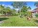 Lush backyard featuring a decorative fountain, mature landscaping, and a clay chiminea at 410 E Gulley Ave, Oakland, FL 34760