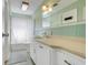 Well-lit bathroom has tiled backsplash, spacious vanity, and shower-tub combination at 410 E Gulley Ave, Oakland, FL 34760