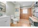 Well-lit bathroom with a tiled walk-in shower, decorative shelving, and modern fixtures at 410 E Gulley Ave, Oakland, FL 34760