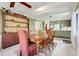 Dining room with a wooden table, seating for six, and a built-in display cabinet at 410 E Gulley Ave, Oakland, FL 34760