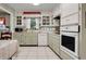 Bright kitchen featuring ample counter space, white cabinetry, and modern appliances at 410 E Gulley Ave, Oakland, FL 34760