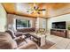 Comfortable living room featuring neutral toned decor, a large window, and tile flooring at 410 E Gulley Ave, Oakland, FL 34760