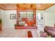 Cozy living room featuring a custom built in entertainment center with fireplace, tile flooring and a view of the kitchen at 410 E Gulley Ave, Oakland, FL 34760