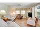 Inviting living room featuring neutral tones, plush seating, and a decorative bookshelf at 410 E Gulley Ave, Oakland, FL 34760