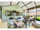 Spacious sunroom with seating, dining area, and a treadmill, perfect for relaxing and staying active at 410 E Gulley Ave, Oakland, FL 34760