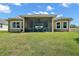 Spacious backyard with a screened-in patio, perfect for enjoying the outdoors with privacy and comfort at 440 Bellissimo Pl, Howey In The Hills, FL 34737
