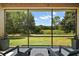 The lanai offers views of a lush, private backyard surrounded by mature trees at 440 Bellissimo Pl, Howey In The Hills, FL 34737