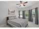 Well-lit bedroom with a ceiling fan and large window at 440 Bellissimo Pl, Howey In The Hills, FL 34737