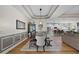 Open-concept dining area with modern lighting, wood floors, and seamless flow to the kitchen and living room at 440 Bellissimo Pl, Howey In The Hills, FL 34737