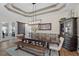 Inviting dining area with tray ceilings, stylish lighting, and convenient access to the kitchen and living space at 440 Bellissimo Pl, Howey In The Hills, FL 34737