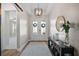 Elegant foyer with a stylish console table, a decorative mirror, and a view into the living space at 440 Bellissimo Pl, Howey In The Hills, FL 34737