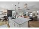 Open-concept kitchen with white cabinets, granite counters, stainless steel appliances, and breakfast bar seating at 440 Bellissimo Pl, Howey In The Hills, FL 34737