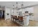 Stylish kitchen features white cabinets, granite counters, a breakfast bar, and stainless steel appliances at 440 Bellissimo Pl, Howey In The Hills, FL 34737