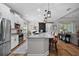 Spacious kitchen featuring white cabinets, granite counters, stainless steel appliances, and a center island at 440 Bellissimo Pl, Howey In The Hills, FL 34737