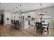 Charming kitchen with white cabinets, granite counters, a breakfast bar, and a cozy eat-in area at 440 Bellissimo Pl, Howey In The Hills, FL 34737