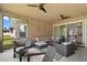 Outdoor living is at its finest in this screened lanai with plenty of seating and backyard views at 440 Bellissimo Pl, Howey In The Hills, FL 34737