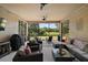 Spacious screened lanai featuring comfortable seating and views of the green backyard at 440 Bellissimo Pl, Howey In The Hills, FL 34737