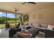 This screened lanai features a spacious seating area with comfortable furniture and an outdoor ceiling fan at 440 Bellissimo Pl, Howey In The Hills, FL 34737