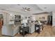 Open concept living room with a tray ceiling and fan flows into the dining room at 440 Bellissimo Pl, Howey In The Hills, FL 34737