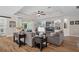 Comfortable living room boasts built-in shelving, a fireplace, and a tray ceiling with fan at 440 Bellissimo Pl, Howey In The Hills, FL 34737