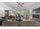 Bright living room featuring coffered ceilings, a ceiling fan, and access to the lanai at 440 Bellissimo Pl, Howey In The Hills, FL 34737