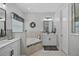 Bright main bathroom with double vanities, tub and large windows at 440 Bellissimo Pl, Howey In The Hills, FL 34737