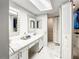 Spacious bathroom featuring a long countertop, double sinks and convenient access to the walk-in closet at 500 Newell Hill Rd # 113D, Leesburg, FL 34748