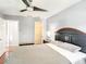 Cozy bedroom with a ceiling fan, dark wood furniture, a comfortable bed, and closet at 500 Newell Hill Rd # 113D, Leesburg, FL 34748